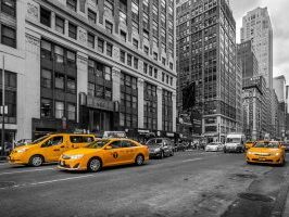 yellow cars on black and white street